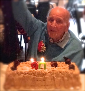 Picture: Smiling, elderly Dad at his birthday party has a huge birthday cake with candles shaped #90. Cat Michaels, Writer