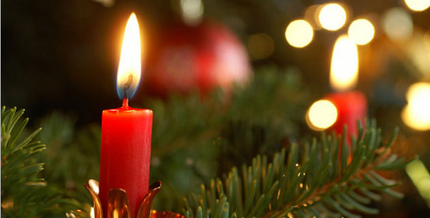 Picture: Red candles glowing in branches of a fir tree