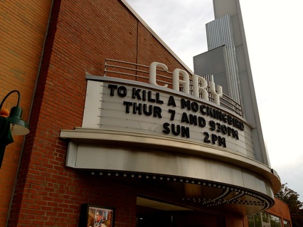 Brick cinema with white metal marquee advertising showing of To Kill a Mockingbird